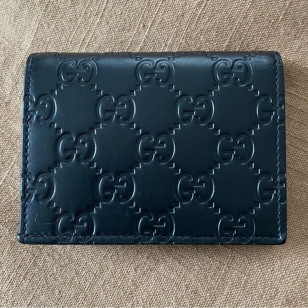 Authentic Gucci GG wallet. Black leather. Comes with box & dust bag.
